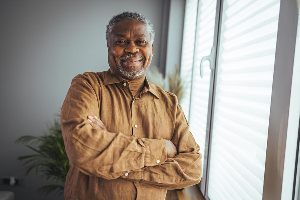 A man crosses his arms and smiles for the camera. The Birmingham Social Security Disability lawyer at The Clarkson Firm can help you at every stage in the process of getting disability benefits.